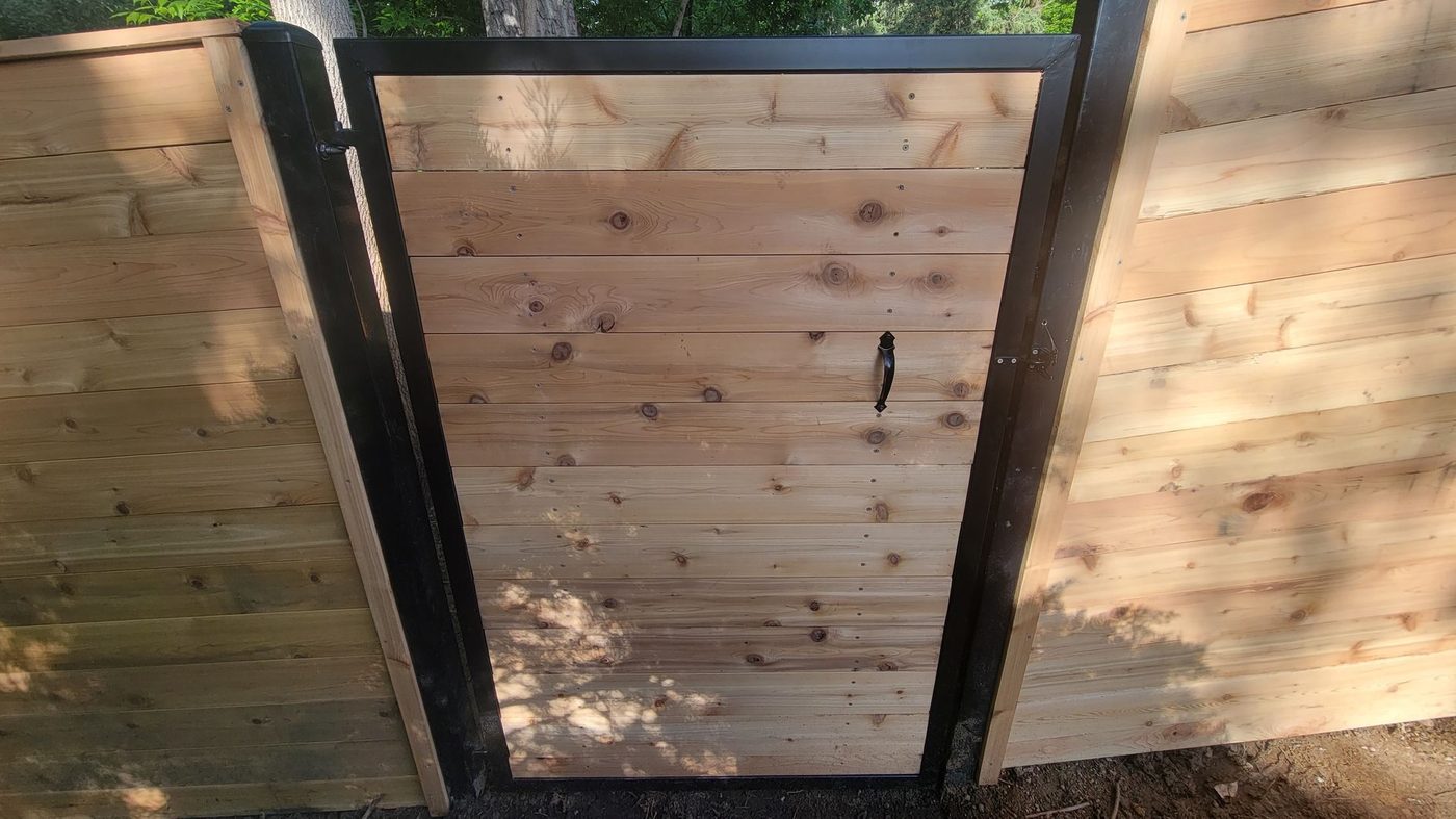 Modern horizontal wood fence with steel gate frame